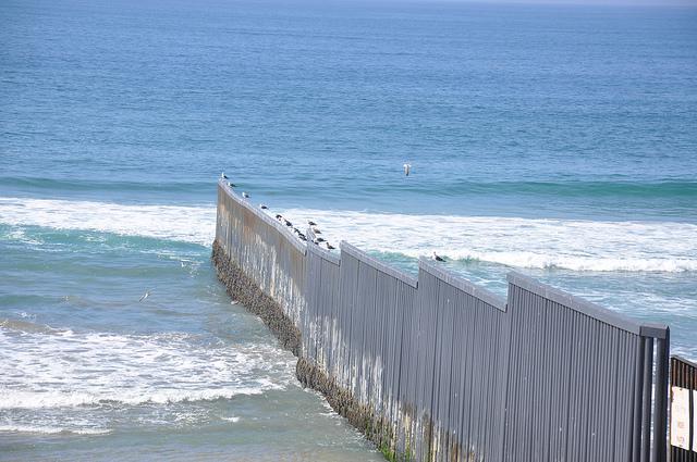 Along the U.S.-Mexico border, fencing stretches into the Pacific (BBC World Service / Creative Commons)