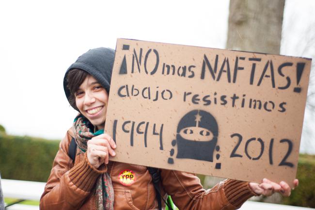 A sign at an anti-TPP protest reads, “No more NAFTAS! We resist from below.” (Caelie Frampton)