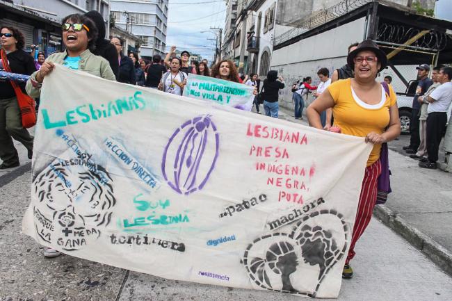 Sign reclaiming marginal LGBT identities reads, “Lesbian, imprisoned, indigenous, black, whore, dyke, carpet muncher, I’m lesbian because I feel like it, direct action, dignity, resistance.” (Producciones y Milagros Agrupación Feminista)