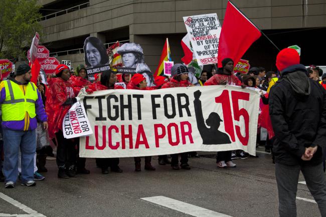 May Day protesters demand both an end to deportations and the raising of the minimum wage to $15 per hour, Chicago, 2014. (Charles Miller)