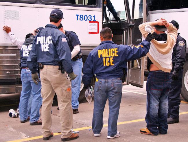 ICE Special Agents (U.S. Immigration and Customs Enforcement) arresting suspects during a raid. (Photo courtesy of ICE/Wikimedia)