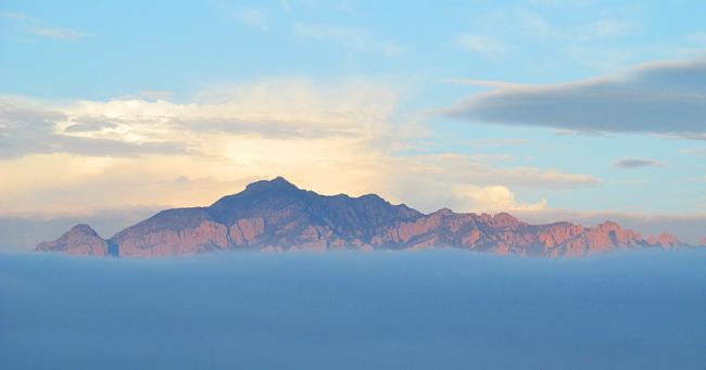 Portal Peak in the Chiricahua Mountains, one of the sky islands, surrounded by clouds. (Wikimedia Commons)