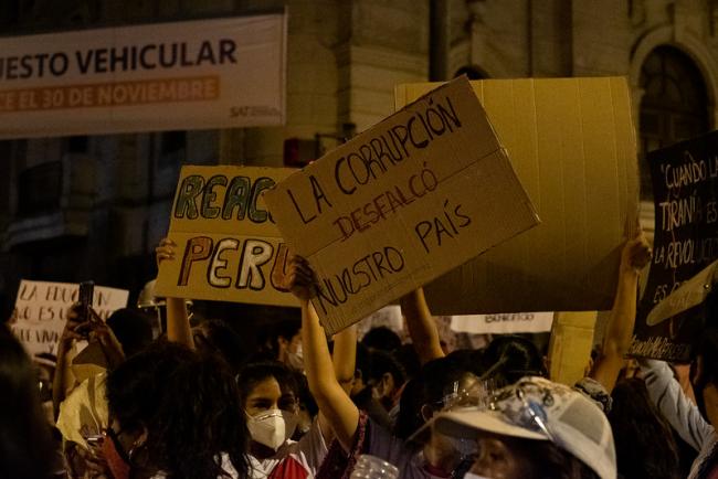 A protester holds a sign reading 