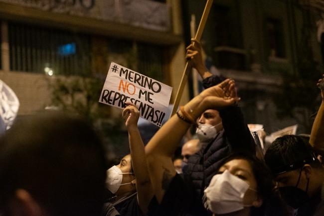 A protester holds a sign reading 