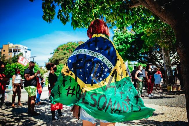 A protester wearing the Brazilian flag painted with 