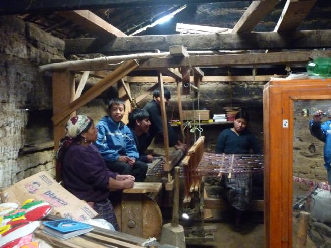 Francisco Puac's widow and children alongside his loom (Sergio Palencia)