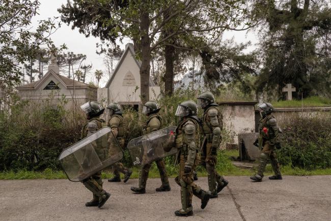 Carabineros patrol at the general cemetery, where protesters gathered to honor Allende and victims of the dictatorship, September 10, 2023. Earlier in the day, Carabineros launched tear gas and fired water cannons at demonstrators. (Anita Pouchard Serra)