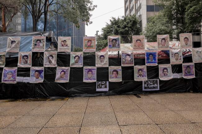 The anniversary march commemorated the 43 disappeared students by displaying posters with their faces and the phrase 