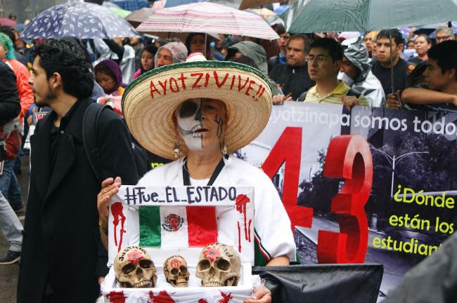 A protester holds a sign that reads 