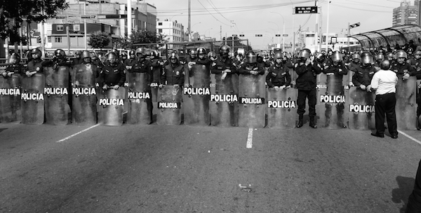 Police line up during a massive protest against the extractive economic model in Lima, 2015 (Photo by Michael Wilson Becerril)