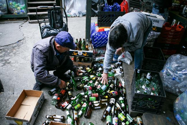 Elderly canners sorting bottles for redemption at Sure We Can (Photo by Carlos Rivera)