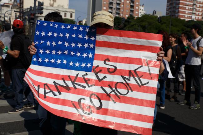 A protester carries a sign reading 