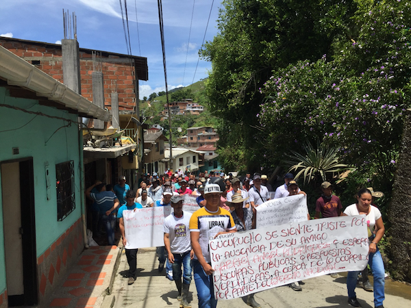 Campesinos march to protest the murder. The sign reads: 