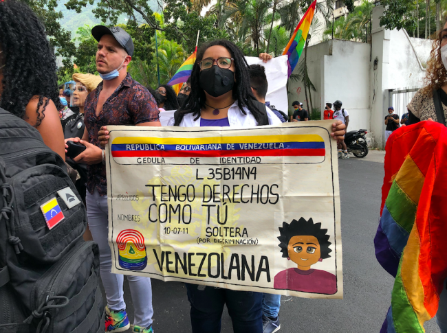 At an LGBTQI rights demonstration in Caracas, a protest sign made to look like an ID card reads: 