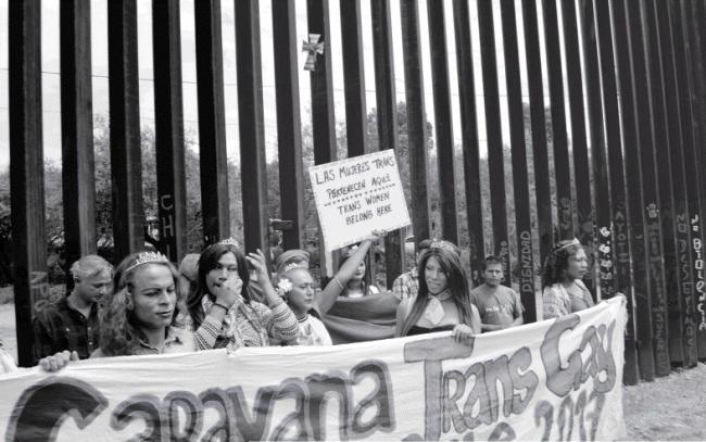 Kevelin, center, holding a sign that reads 