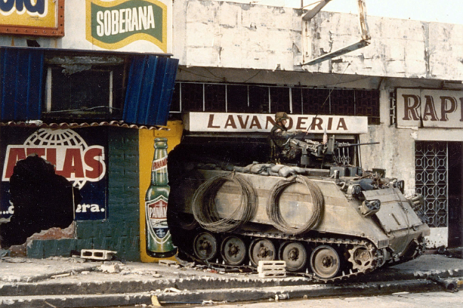 A U.S. armored personnel carrier stands guard in a destroyed laundromat in Panama City on the second day of the U.S. invasion of Panama, December 21, 1989. (U.S. Department of Defense / Public Domain)