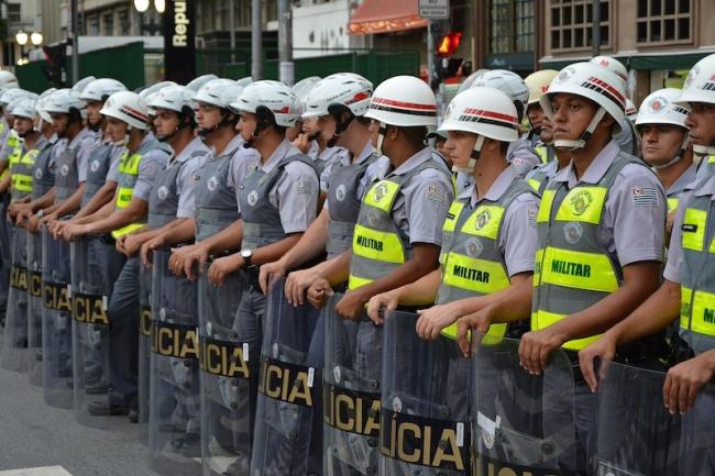 Brazilian Military Police stand equipped in riot gear at the São Paulo World Cup protests on June 12, 2014. (Wikimedia Commons/Ben Tavener/CC BY 2.0)